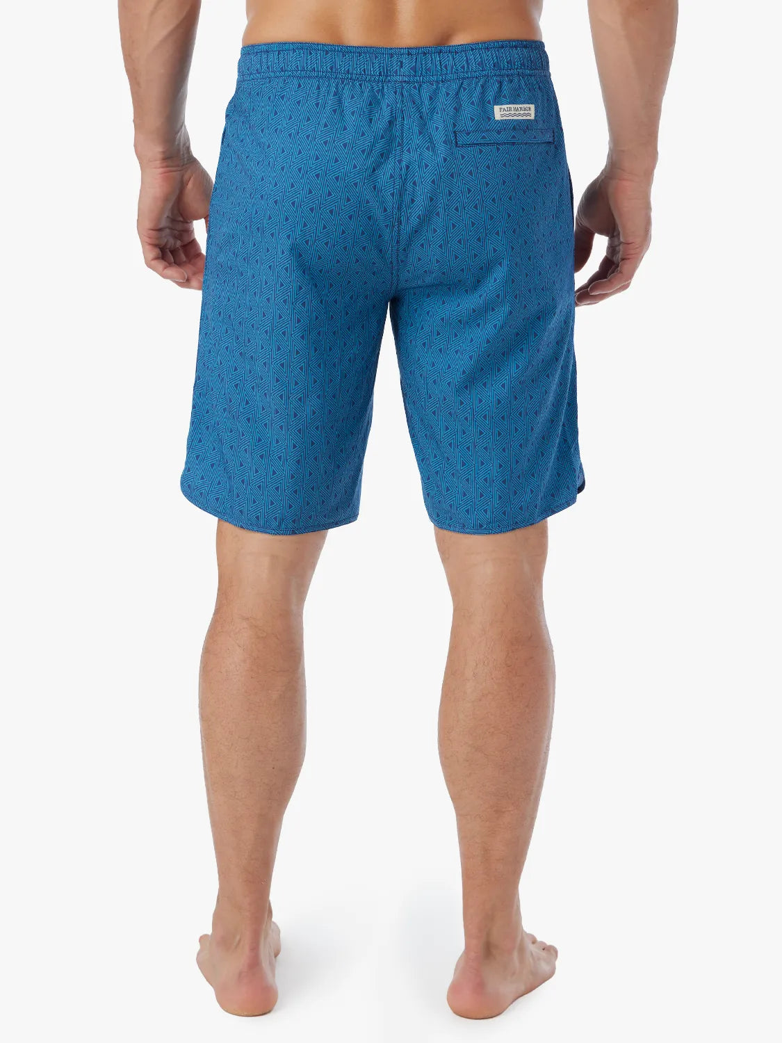 Person wearing electric blue geometric patterned Anchor Trunk in 10 inch inseam with a drawstring waistband and view of back.