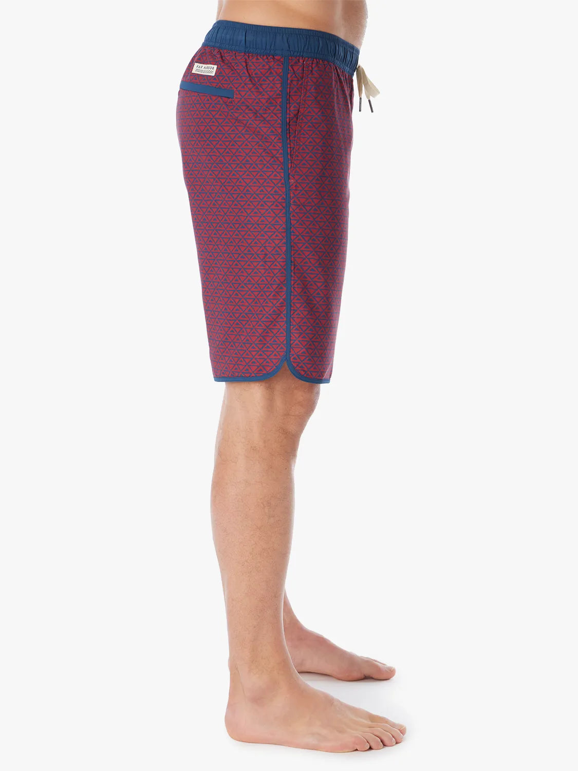 Person wearing a pair of Anchor Trunks with a nautical red wavy geo pattern in 10 Inch inseam. Featuring a drawstring waist and side view of trunk, with a white background.