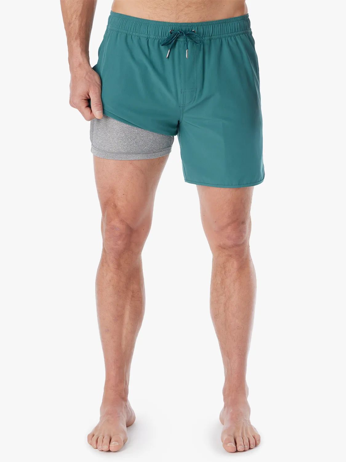 Person wearing 6 inch anchor trunks in seapine color, showing the liner on a white background.
