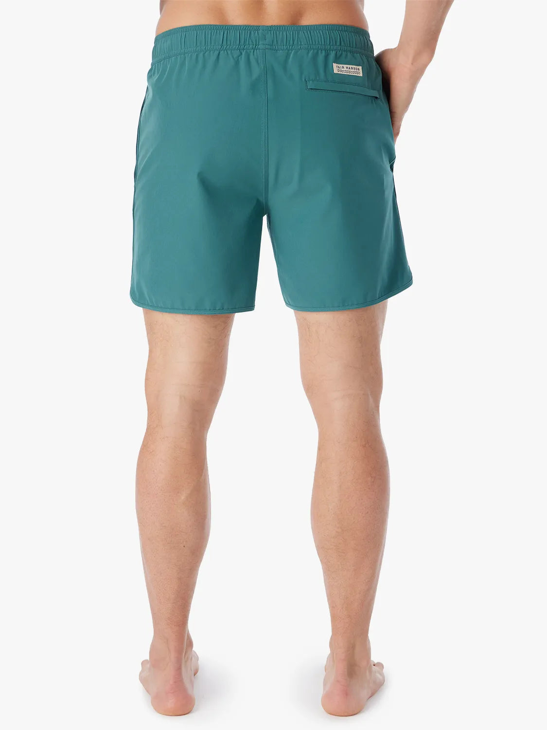 Person wearing 6 inch anchor trunks in seapine color, showing the back view on a white background.