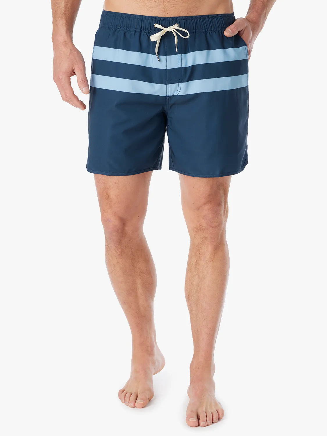 A person wearing a pair of 6 inch navy anchor trunk shorts with two light blue horizontal stripes and a drawstring waist with a white background.