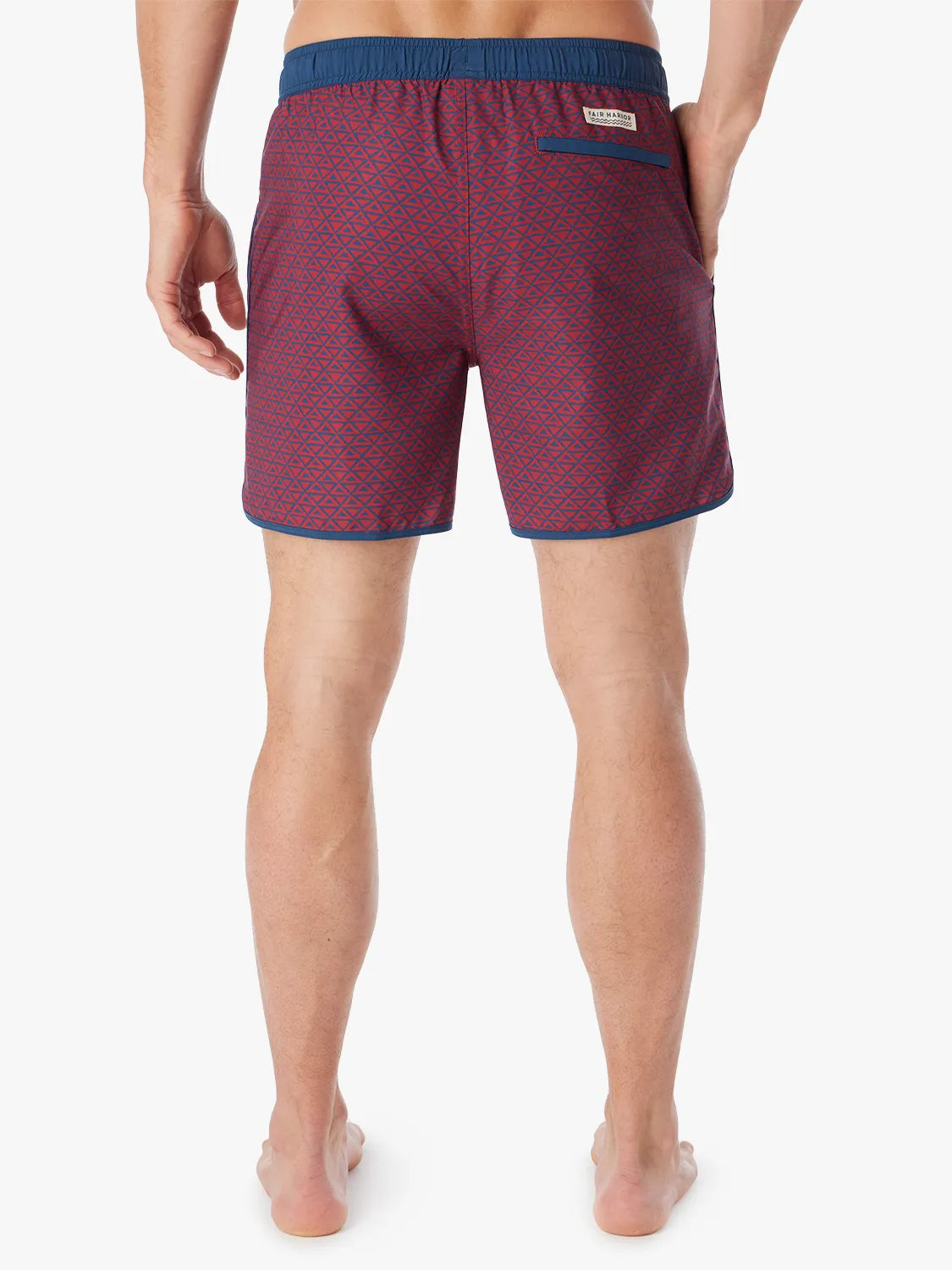 Person wearing a pair of Anchor Trunks with a nautical red wavy geo pattern in 6 Inch inseam. Featuring a drawstring waist and back view of trunk, with a white background.