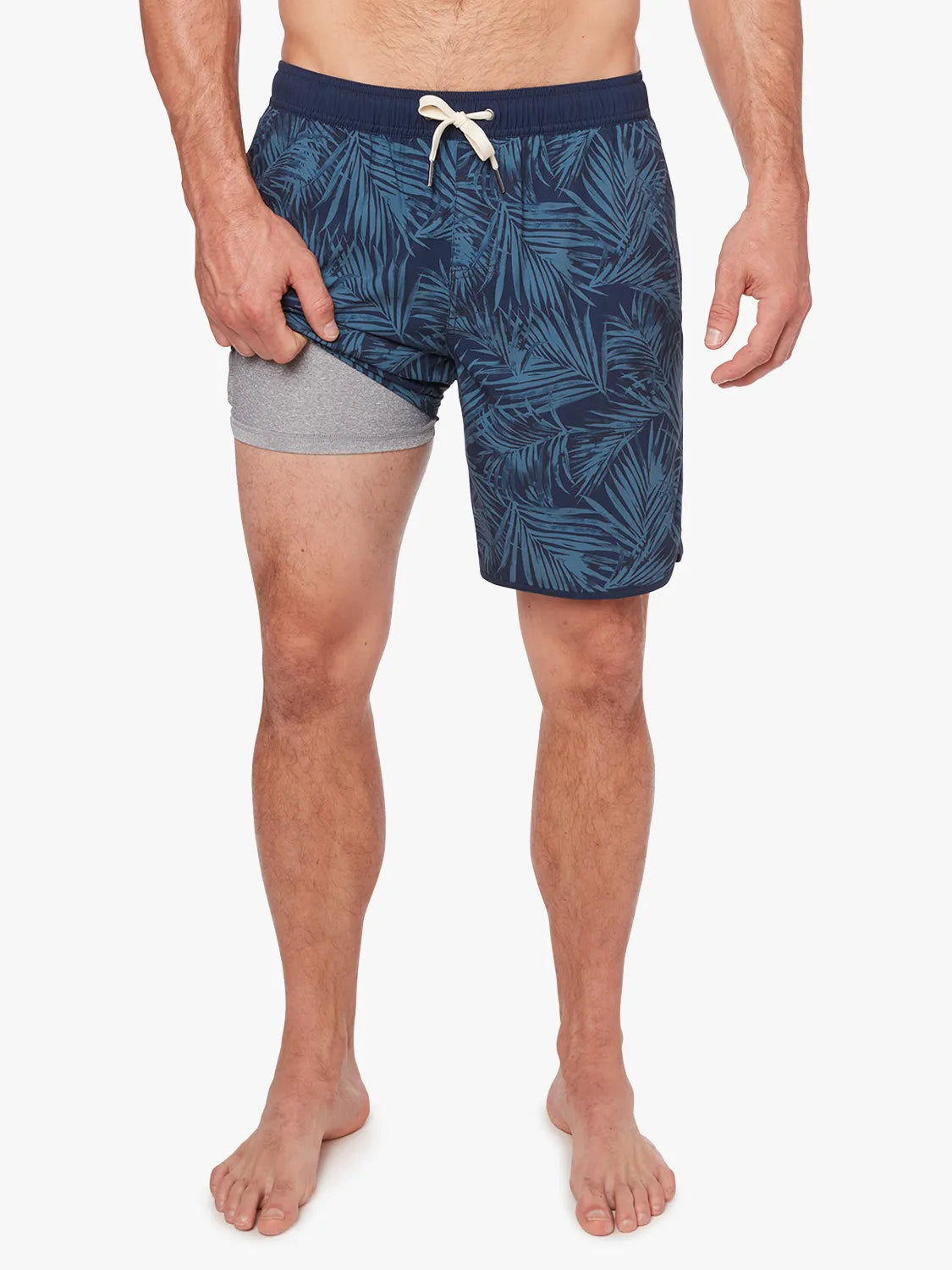 Person wearing grey and navy floral  patterned Anchor Trunk in 8 inch inseam, showing liner on a white background