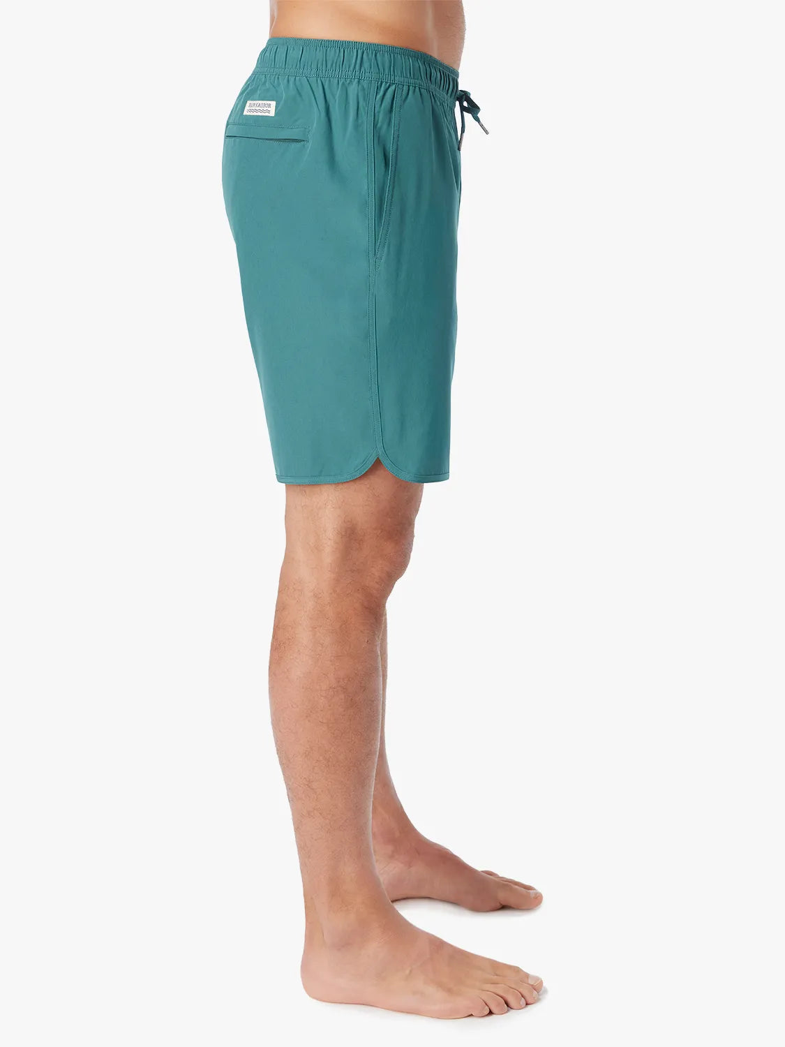 Person wearing 8 inch Anchor Trunk in seapine color, showing side view on a white background.