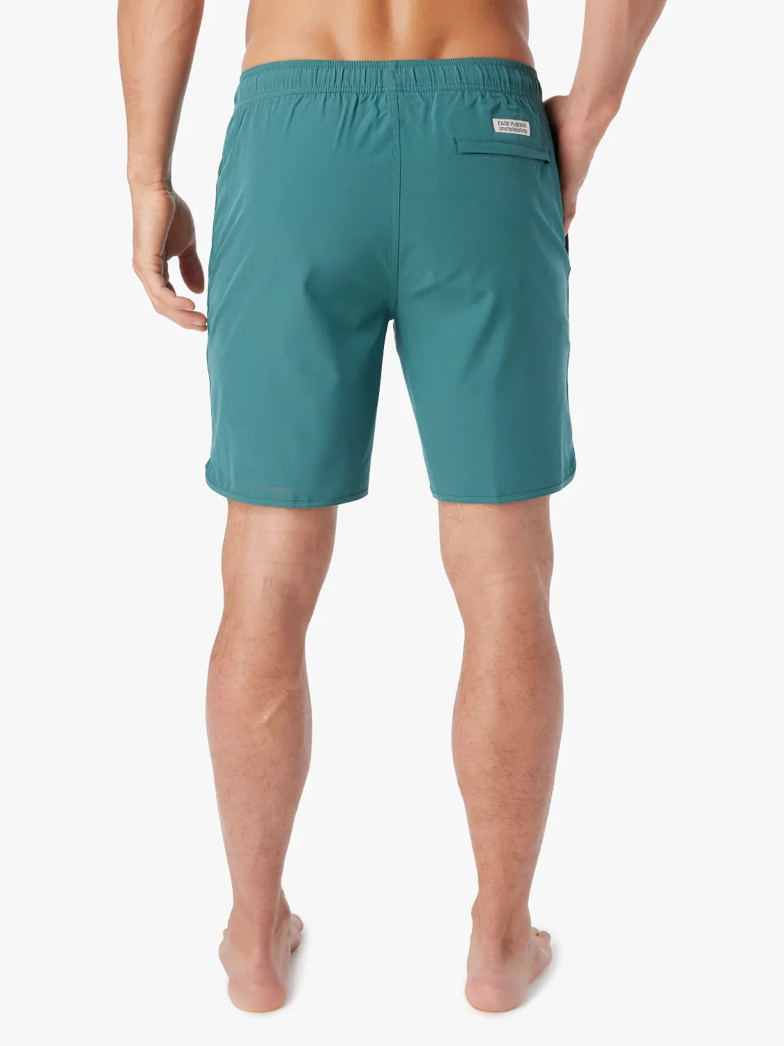 Person wearing 8 inch anchor trunk in seapine color, showing the back view on a white background.