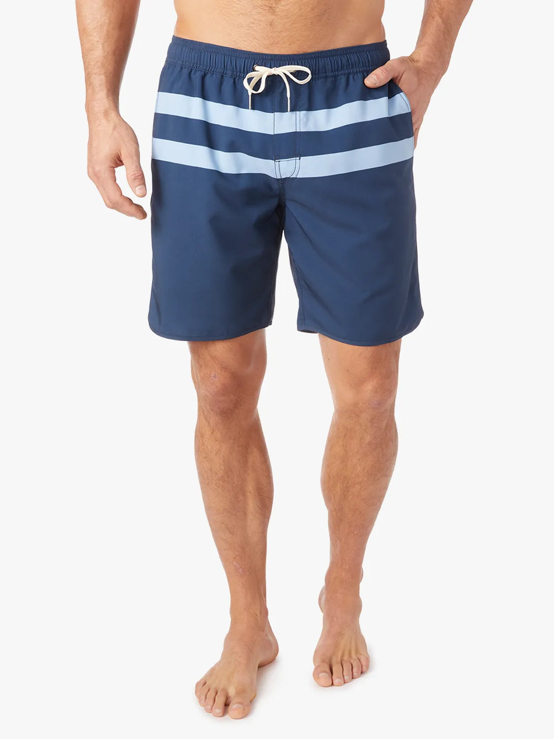 A person wearing a pair of 8 inch navy anchor trunk shorts with two light blue horizontal stripes and a drawstring waist with a white background.