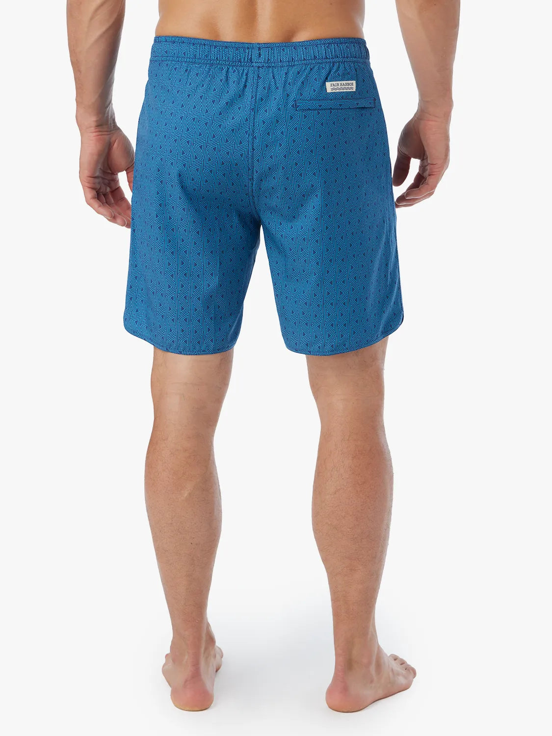 Person wearing electric blue geometric patterned Anchor Trunk in 8 inch inseam with a drawstring waistband and view of back.