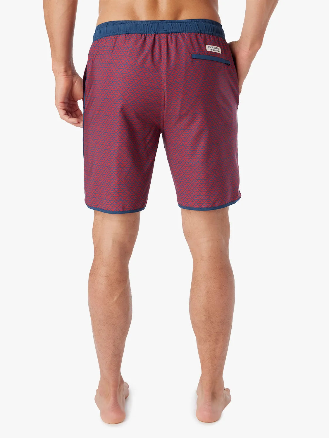 Person wearing a pair of Anchor Trunks with a nautical red wavy geo pattern in 8 Inch inseam. Featuring a drawstring waist and back view of trunk, with a white background.