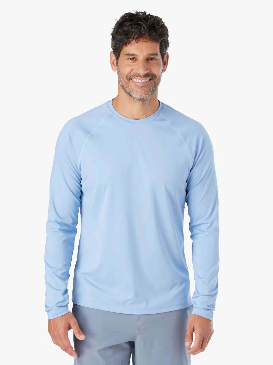 A person wearing the long-sleeved light blue Anchor Rashguard with a crewneck design.