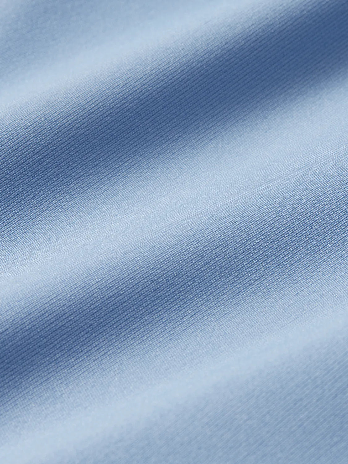 Swatch of light blue anchor rashguard fabric.