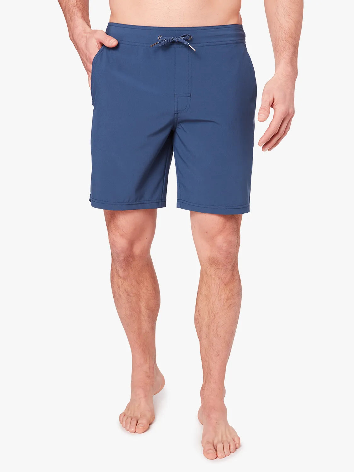 Person wearing navy blue ozone trunks with a drawstring on a white background