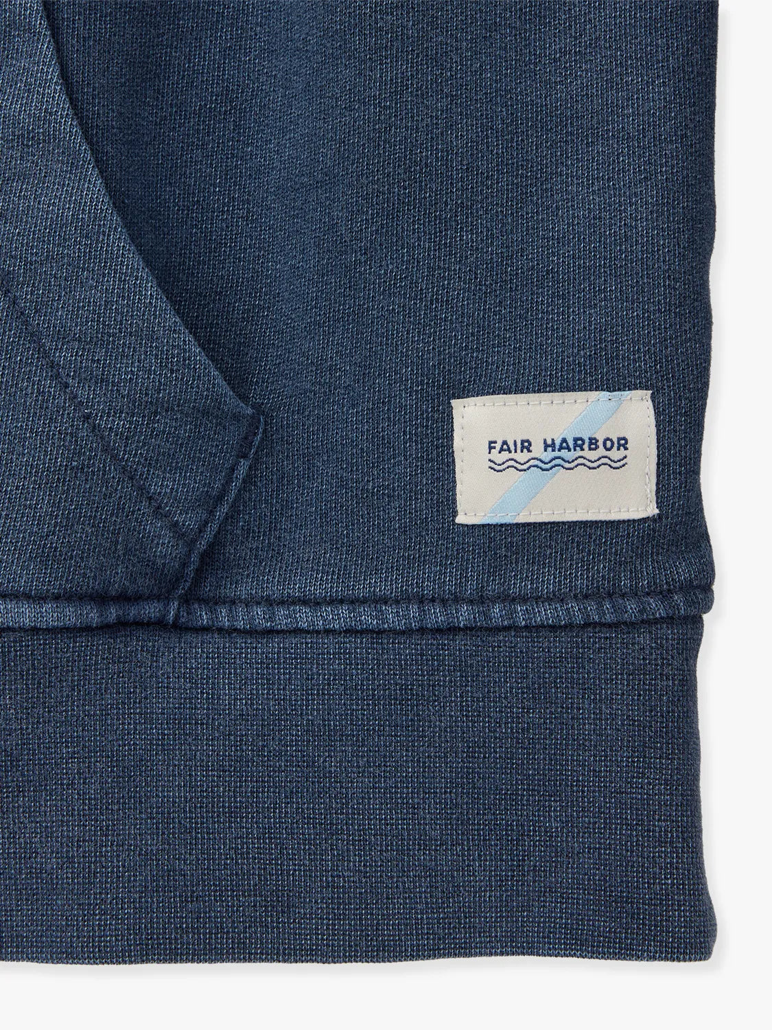 Close up of navy blue saltaire hoodie trim with visible brand logo.
