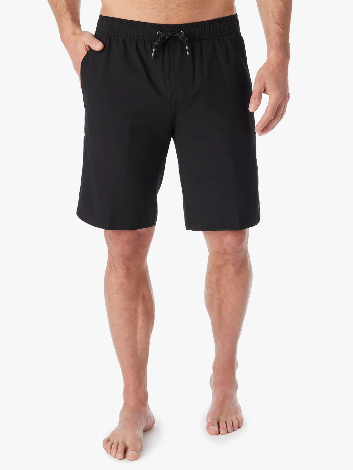 A person wearing a pair of black 10 inch Anchor Trunks on a white background