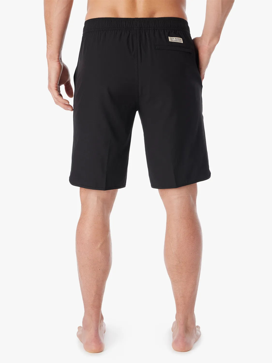 A person wearing a pair of black 10 inch Anchor Trunks on a white background, showing the back view.