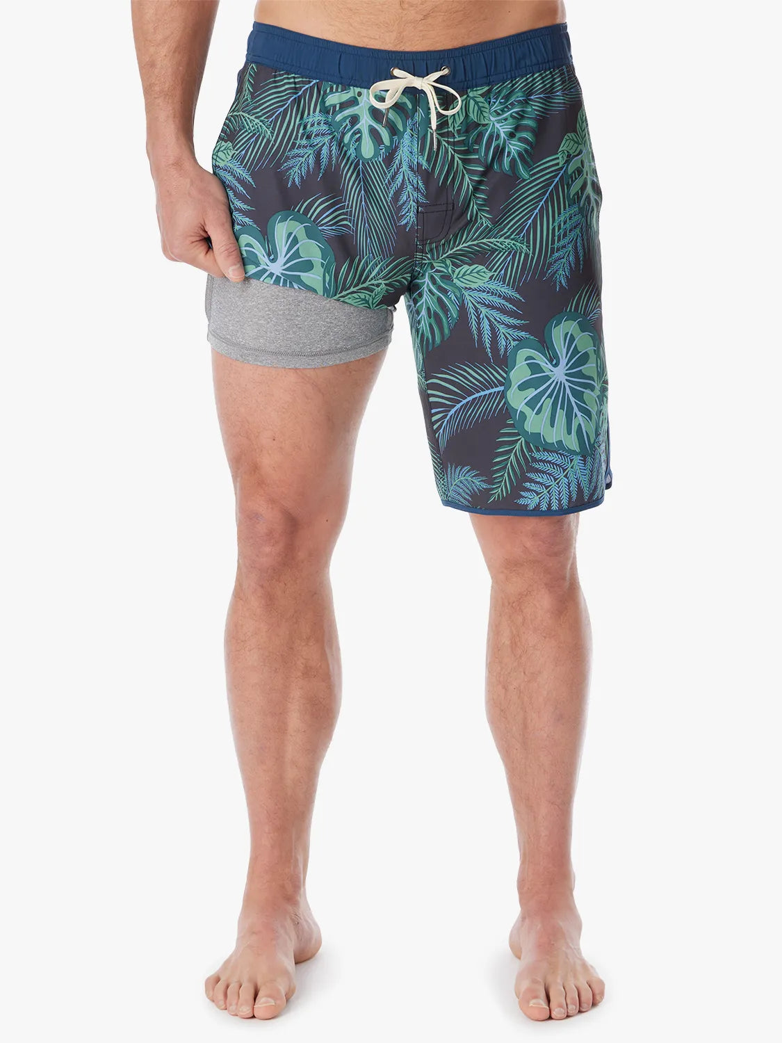 A pair of Anchor Trunk in 10 inch inseam with a navy blue and green leaf pattern, featuring a drawstring waist and showing the liner on a white background. 
