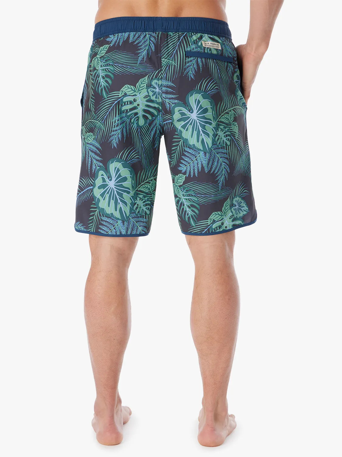 A pair of Anchor Trunk in 10 inch inseam with a navy blue and green leaf pattern, showing the back view on a white background. 