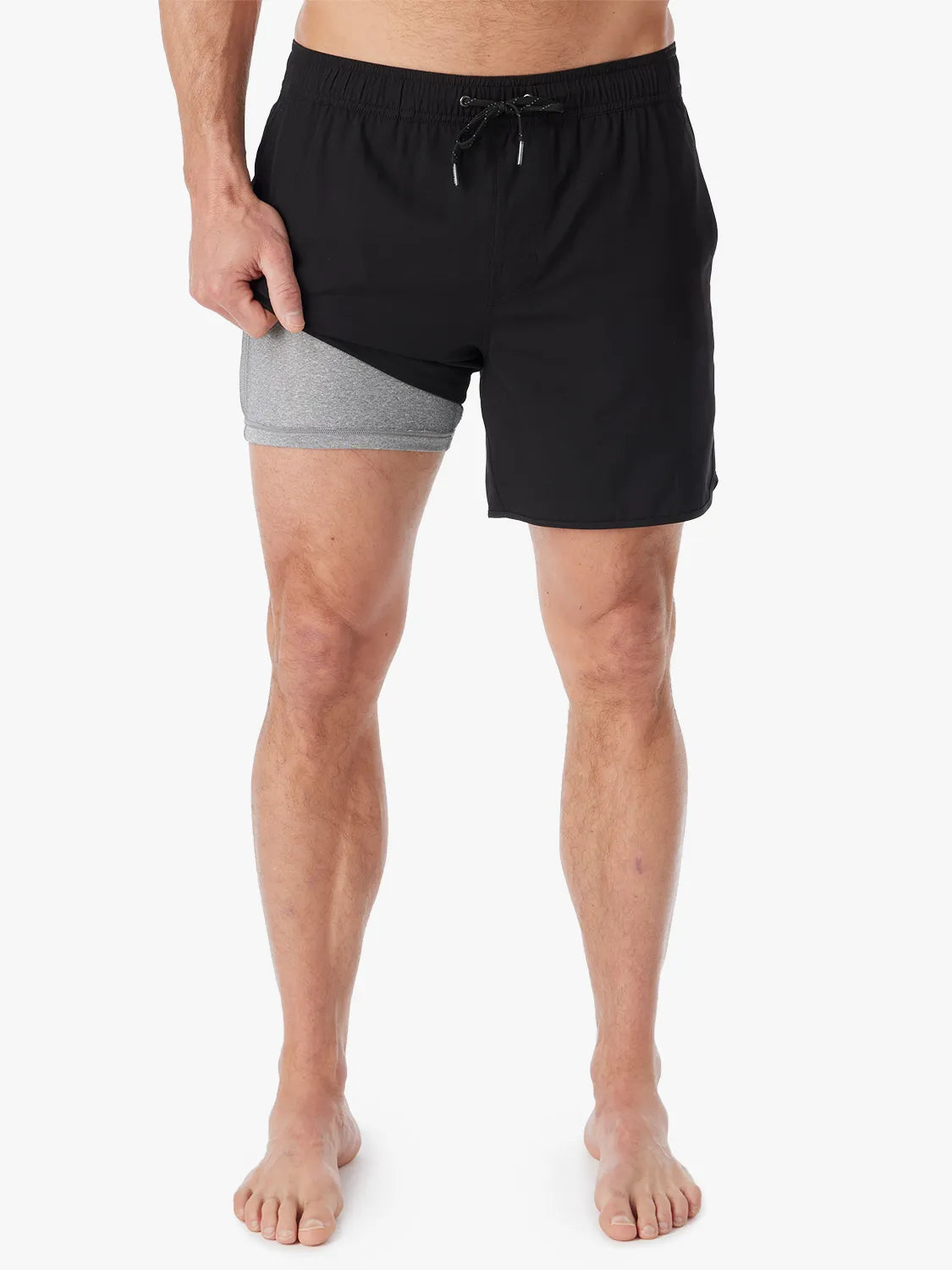 A person wearing a pair of black 6 inch Anchor Trunks on a white background, showing the short lining. 