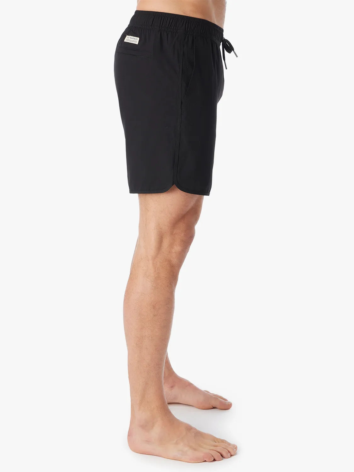 A person wearing a pair of black 6 inch Anchor Trunks on a white background, showing the side view. 