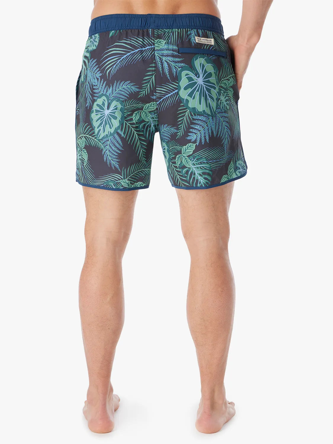 A pair of Anchor Trunk in 6 inch inseam with a navy blue and green leaf pattern, showing the back view on a white background. 