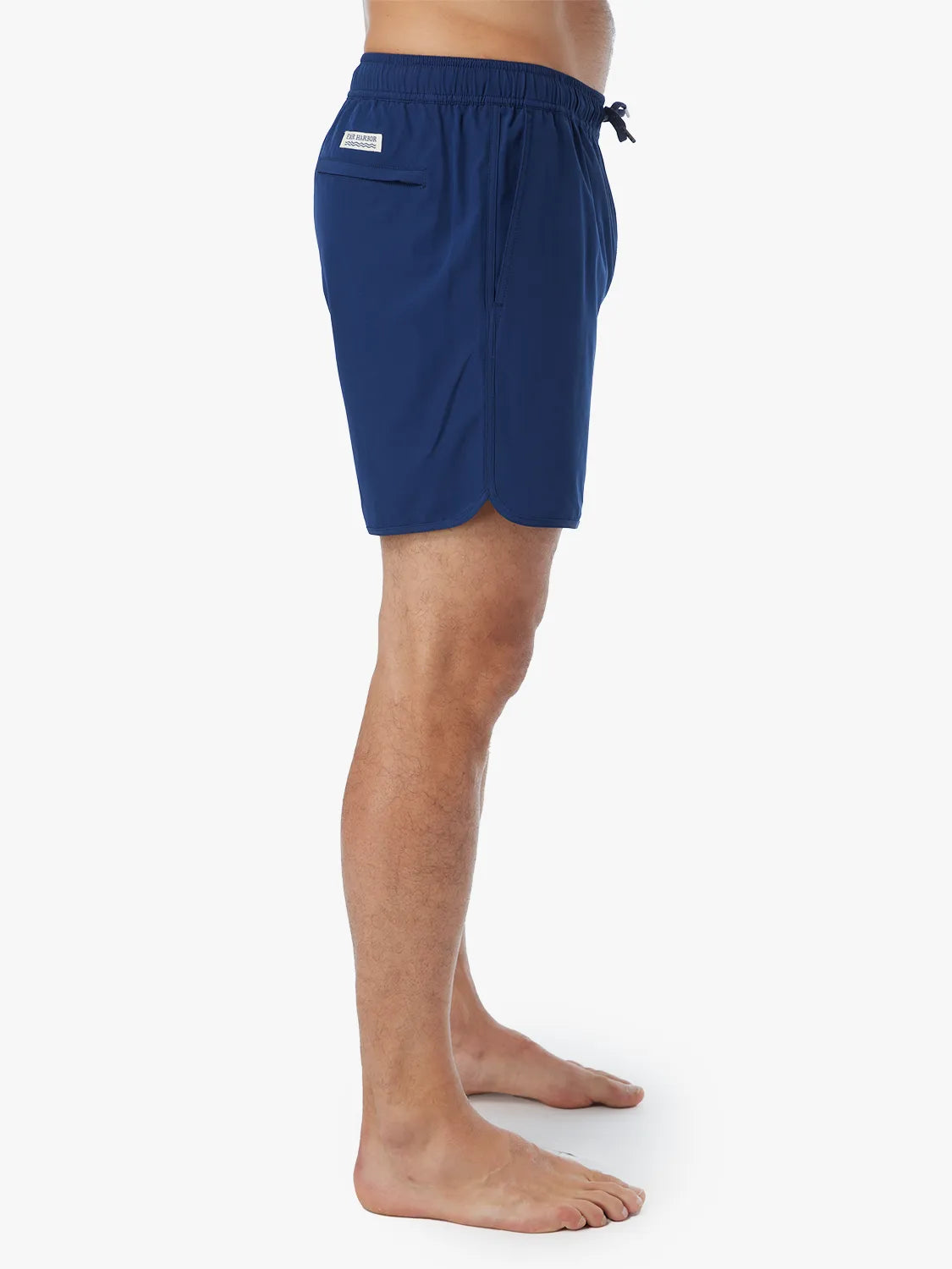 Person wearing navy-colored Anchor Trunk in 6 inch inseam showing the side view, displayed against a white background.