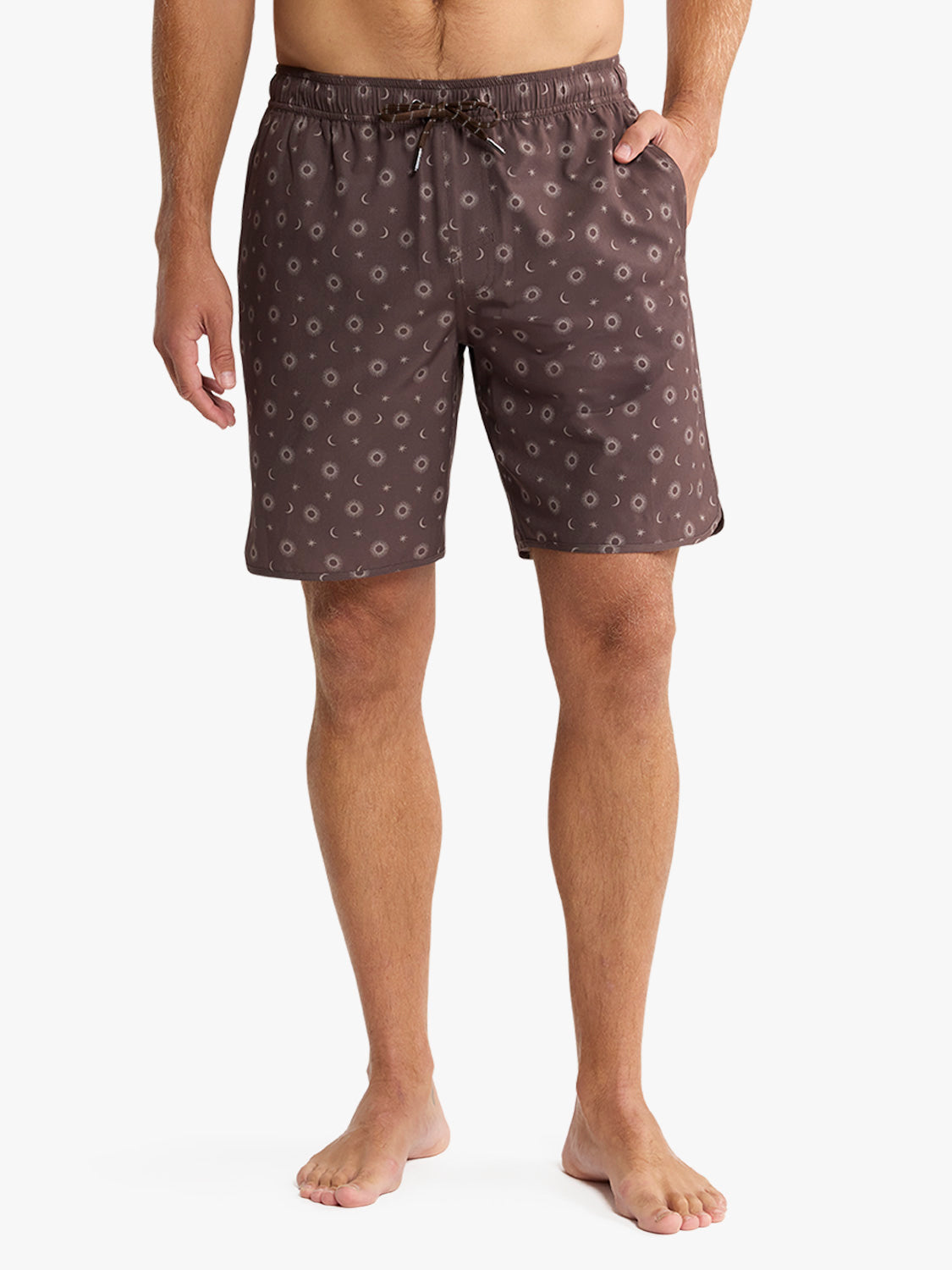 Man wearing patterned shorts on a white background