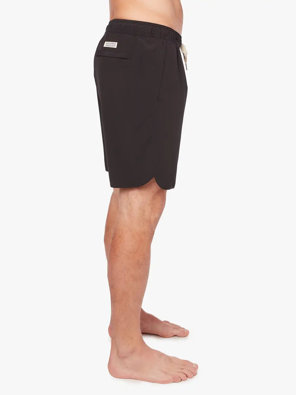 A person wearing a pair of black 8 inch Anchor Trunks on a white background, showing the side view. 