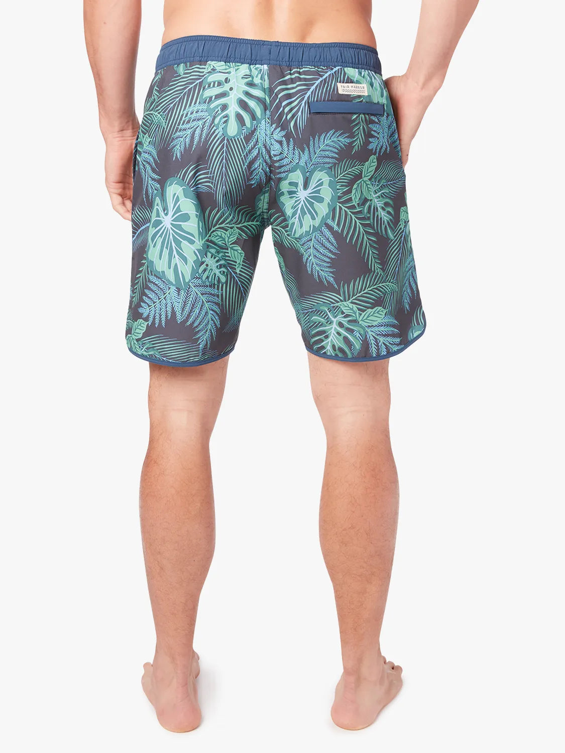 A pair of Anchor Trunk in 8 inch inseam with a navy blue and green leaf pattern, showing the back view on a white background. 