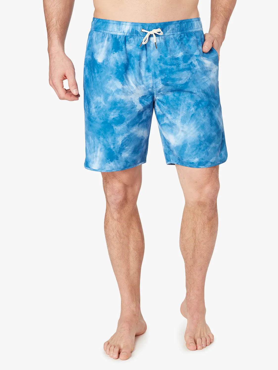 A person wearing a pair of blue tie-dye Anchor Trunk in 8 inch inseam with a drawstring waist and hand in side pocket. 