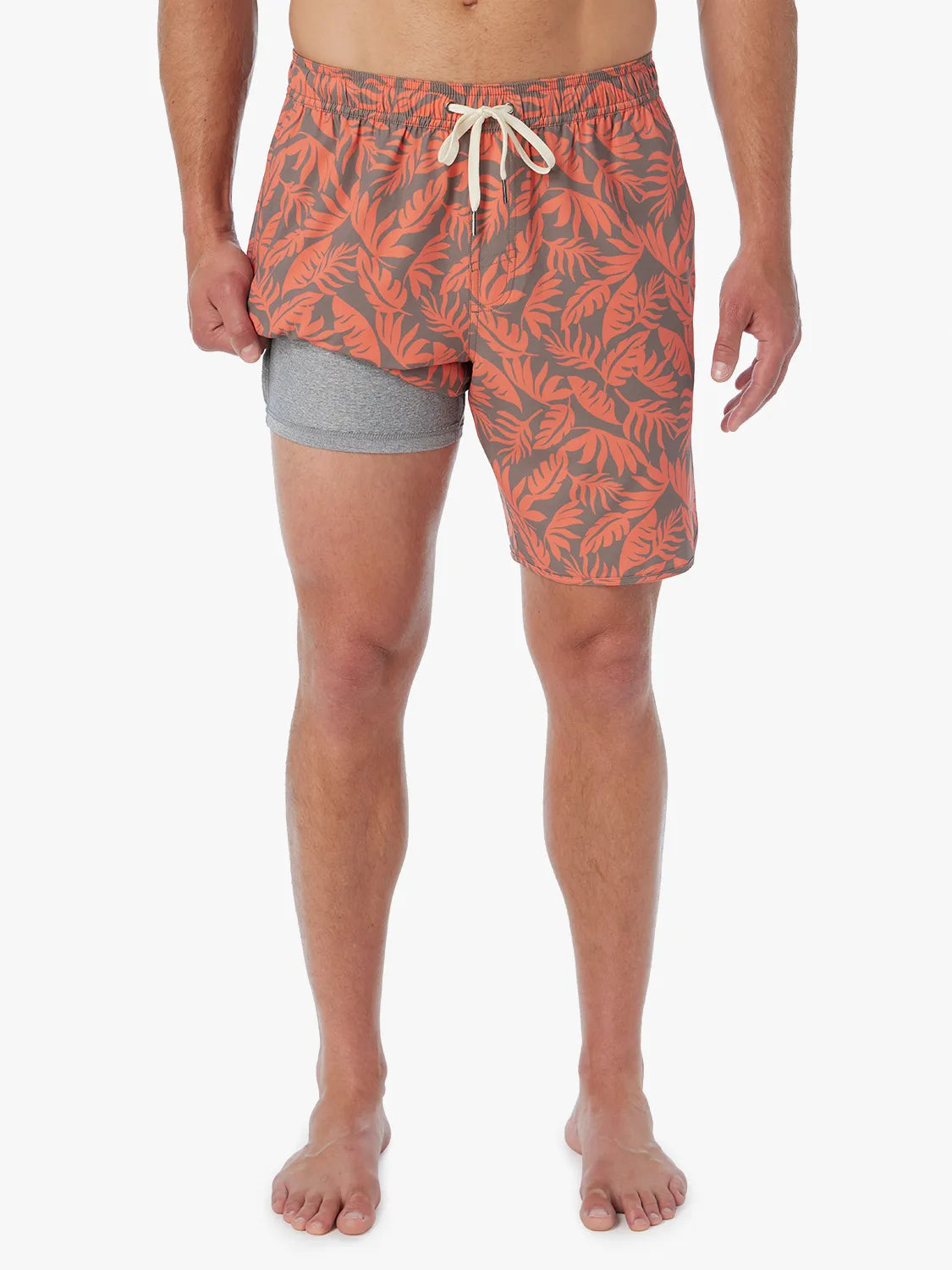 Person wearing orange and brown tropical leaf patterned Anchor Trunk, showing liner on a white background