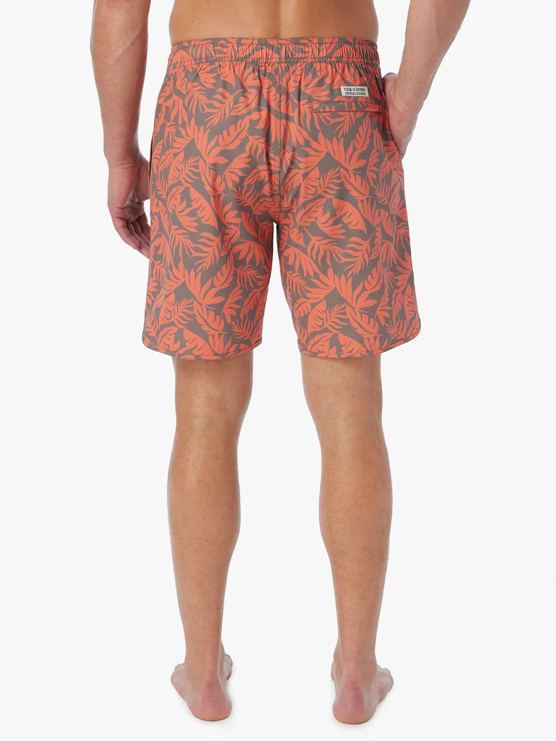 Person wearing orange and brown tropical leaf patterned Anchor Trunk  on a white background