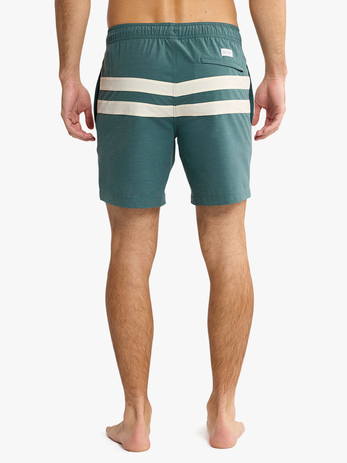 Person wearing teal swim shorts with a white stripe on a white background