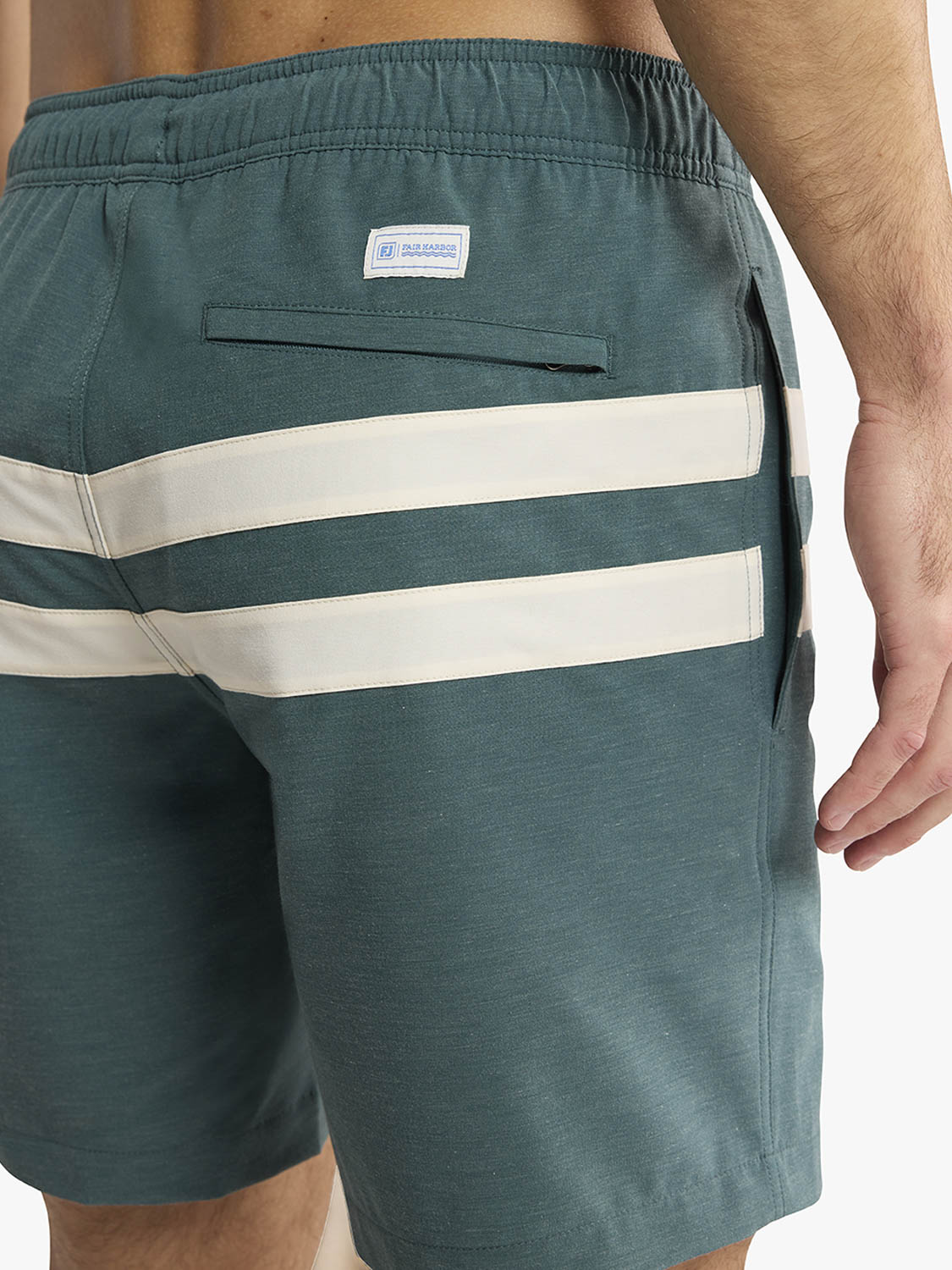 Green shorts with white stripes and a brand logo on a white background