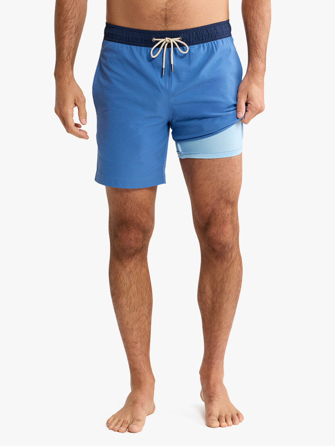 Blue swim shorts with a white drawstring on a white background