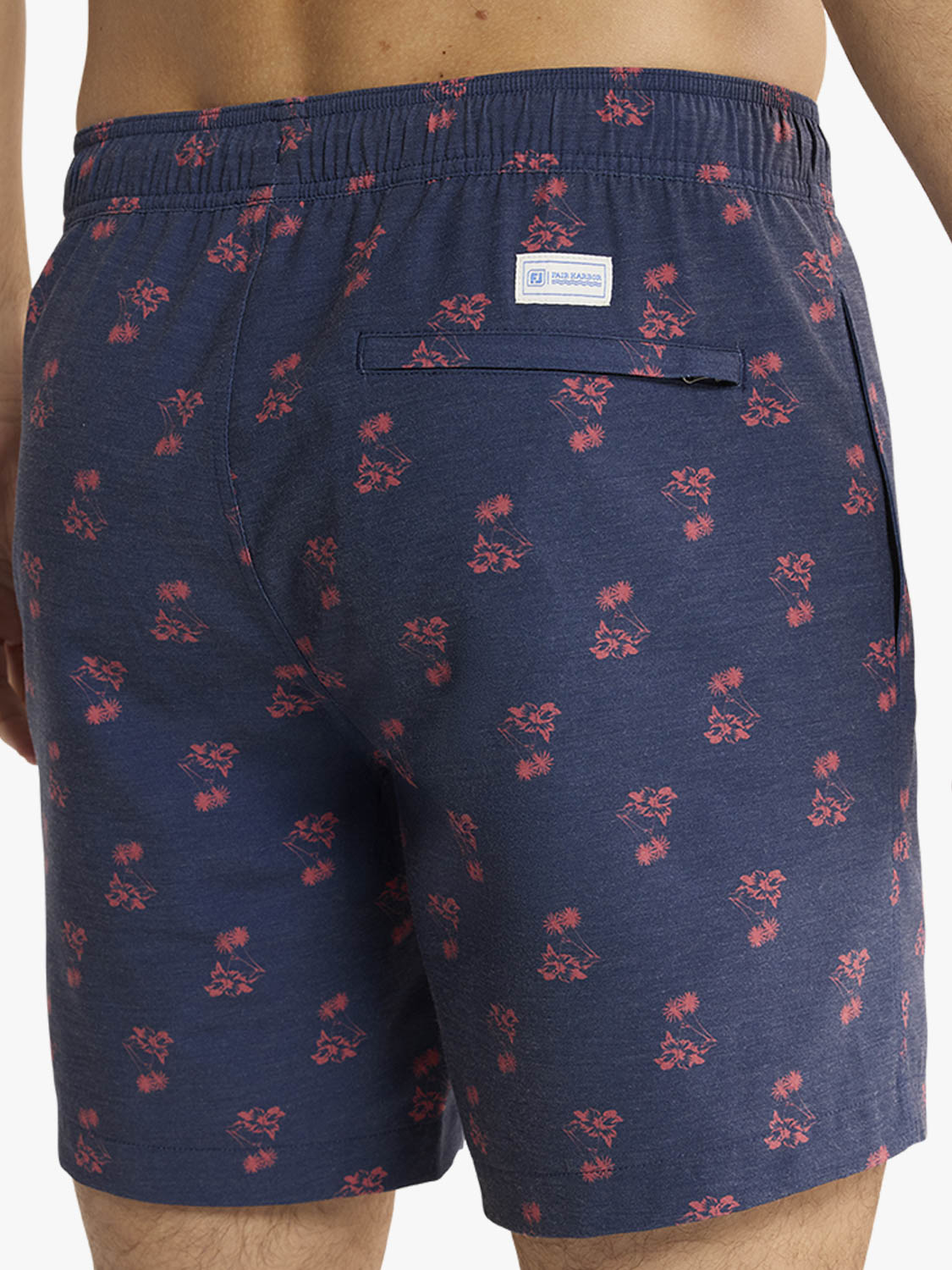 Navy blue shorts with red floral pattern worn by a person on a white background