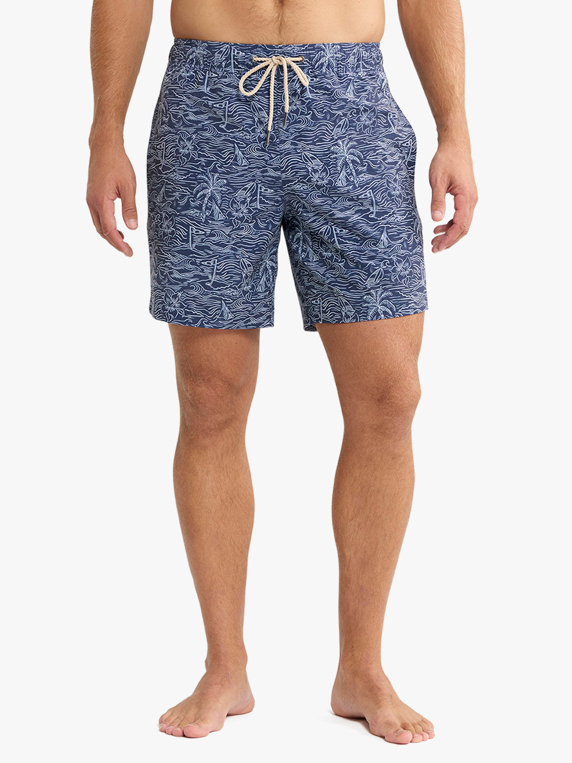 Person wearing blue patterned shorts on a white background