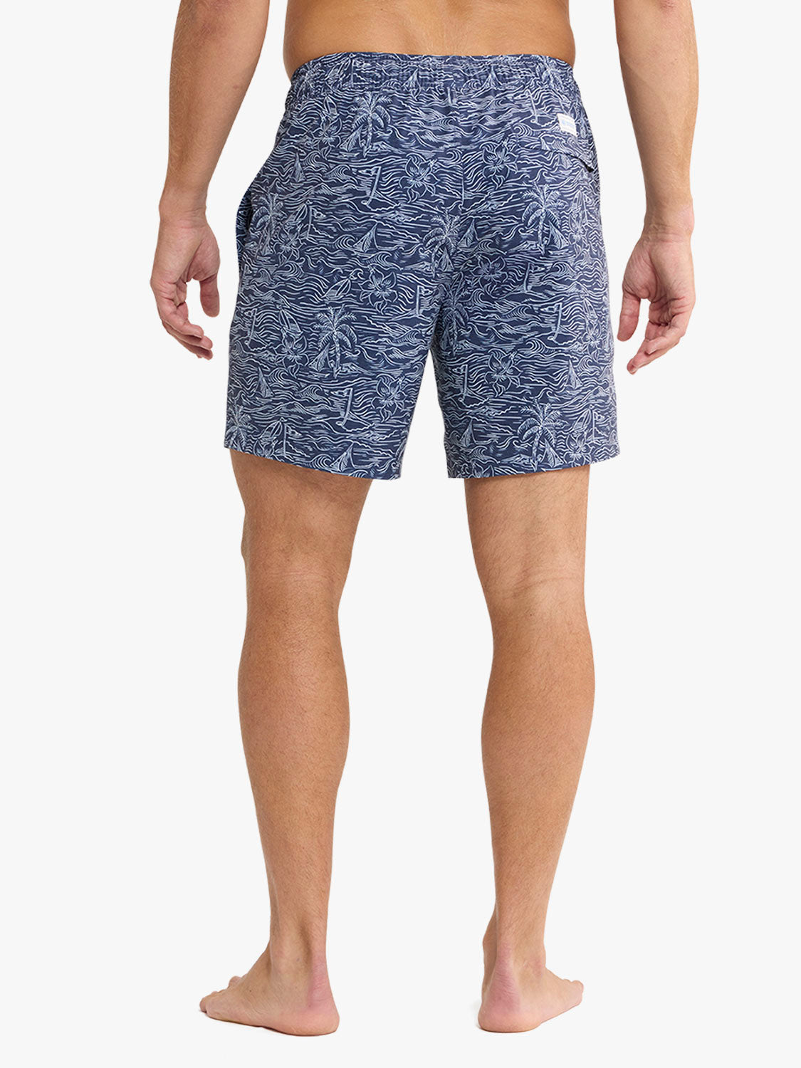 Person wearing blue patterned shorts on a white background