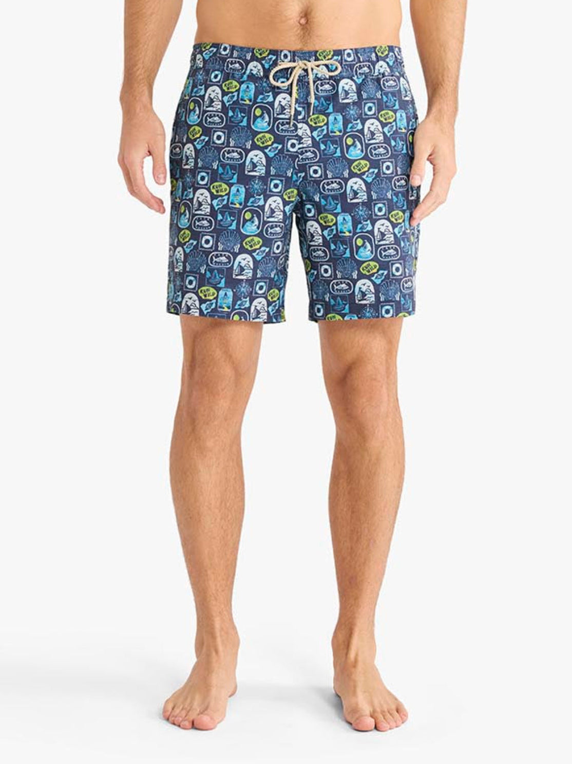 Man wearing blue floral swim shorts on a white background
