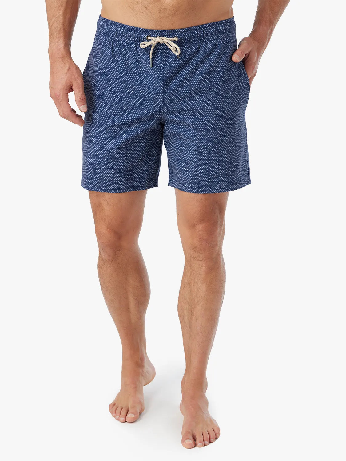 Person wearing Blue diamond patterned Bayberry Trunk with a drawstring and a hand in side pocket against a white background