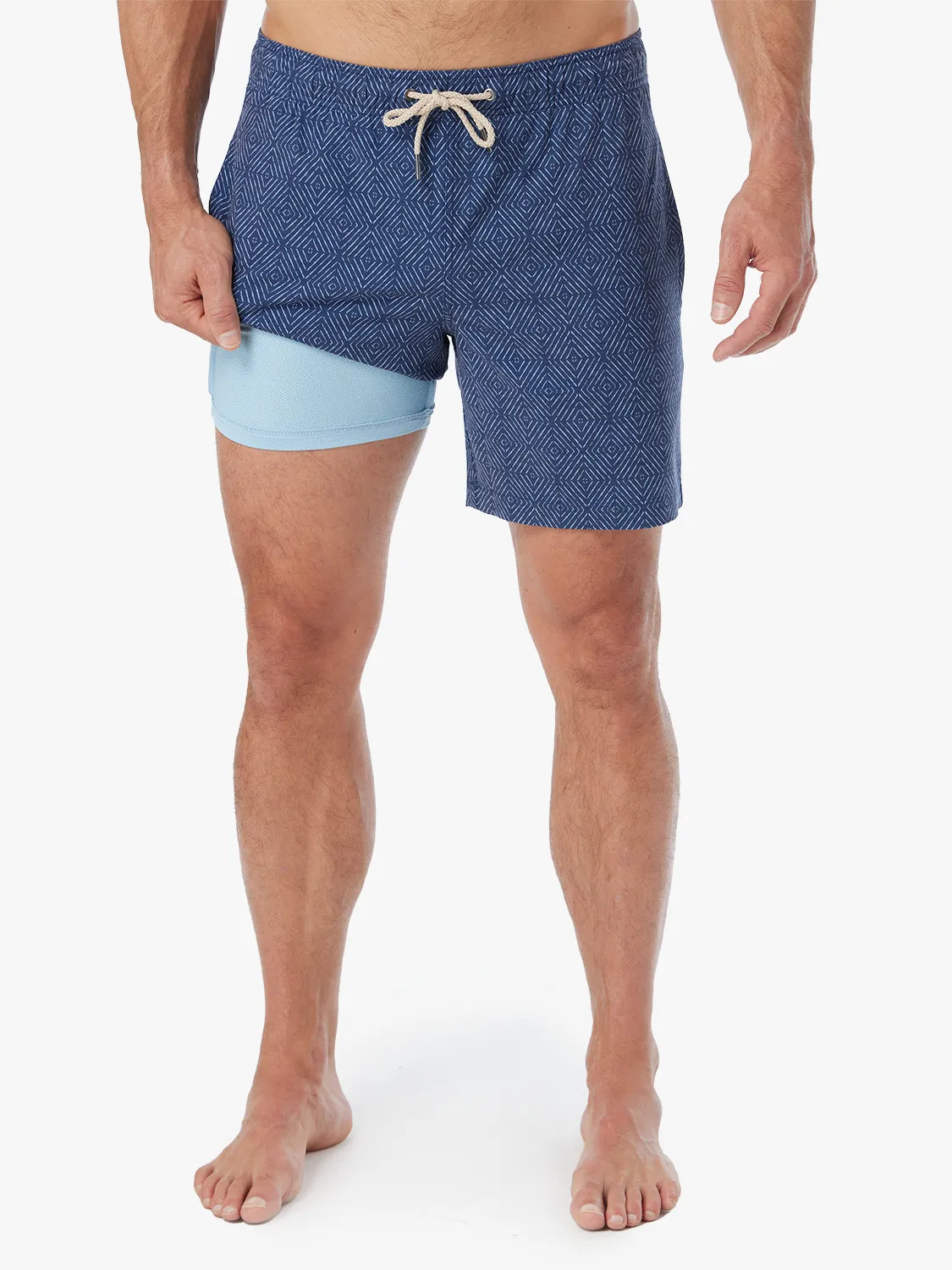 Person wearing Blue diamond patterned Bayberry Trunk with a drawstring and showing the liner against a white background