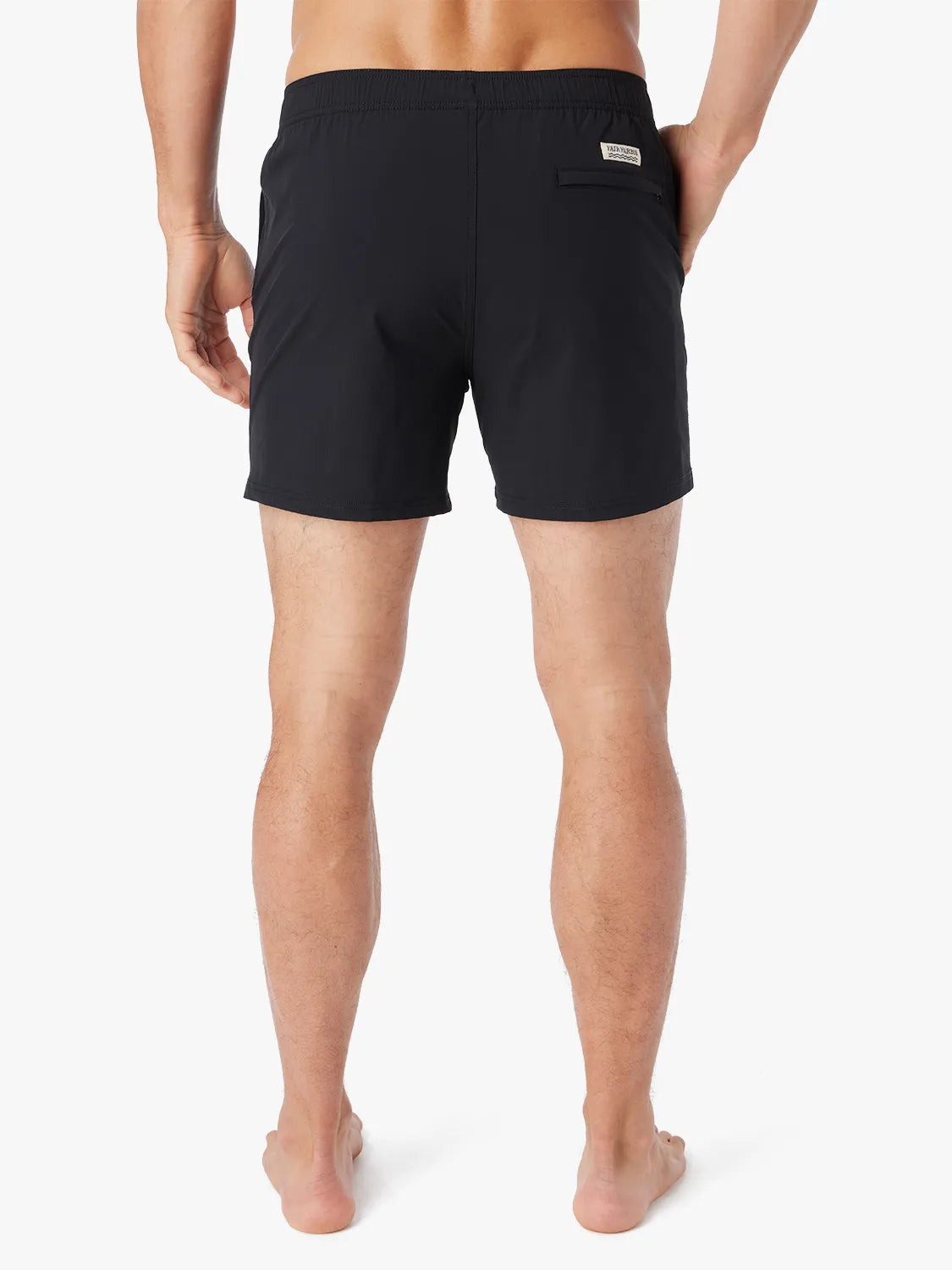 Person wearing solid black bungalow trunk with drawstring on a white background. Showing the back view.