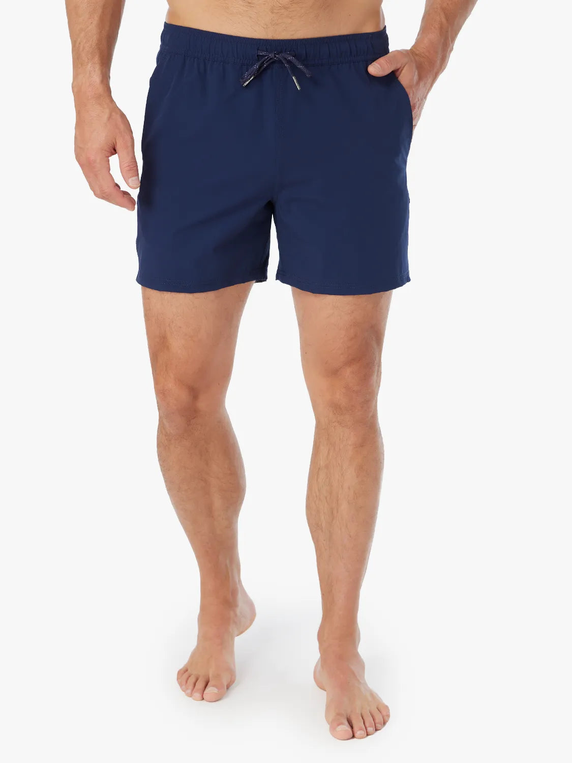 Person wearing pair of navy blue bungalow trunks with drawstring on a white background