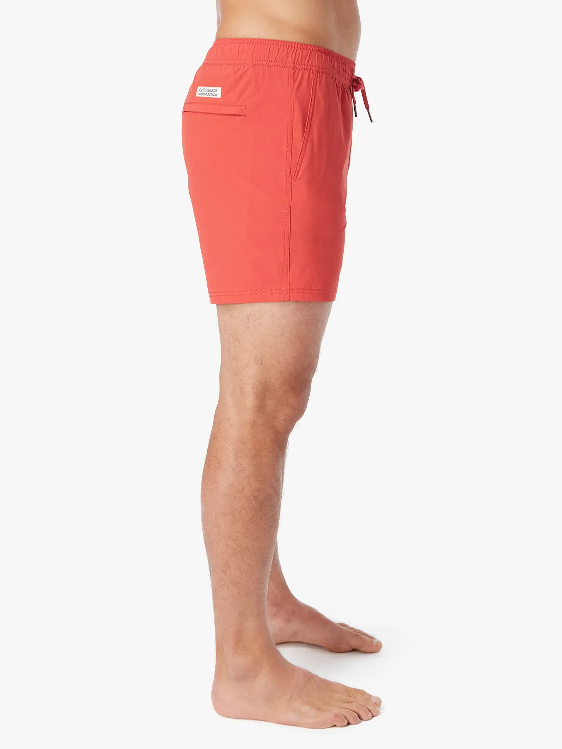 Person wearing solid red bungalow trunk with drawstring on a white background. Showing the side view.
