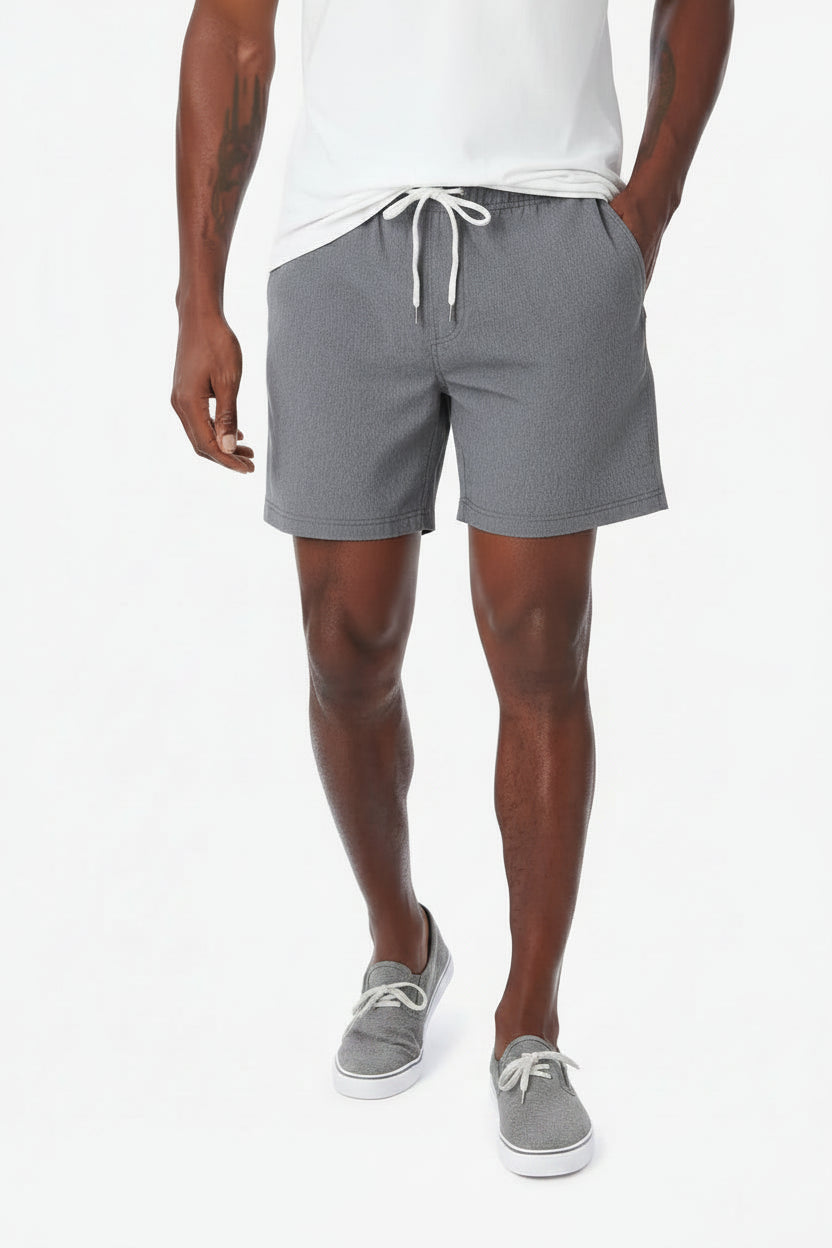 Person wearing gray shorts with a white drawstring on a white background
