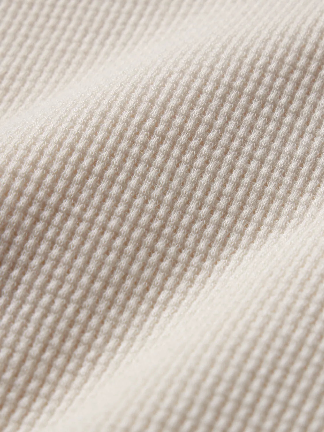 Close up of waffle knite fabric in cream color