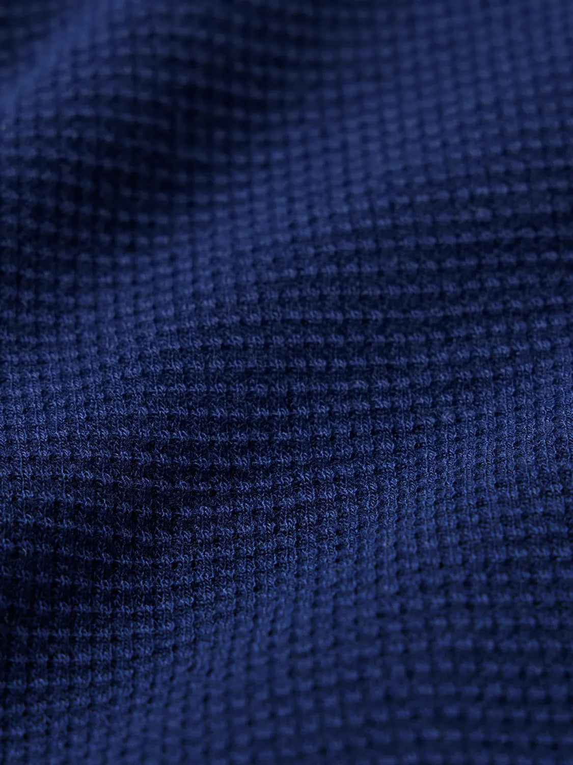 Close up of navy blue waffle fabric