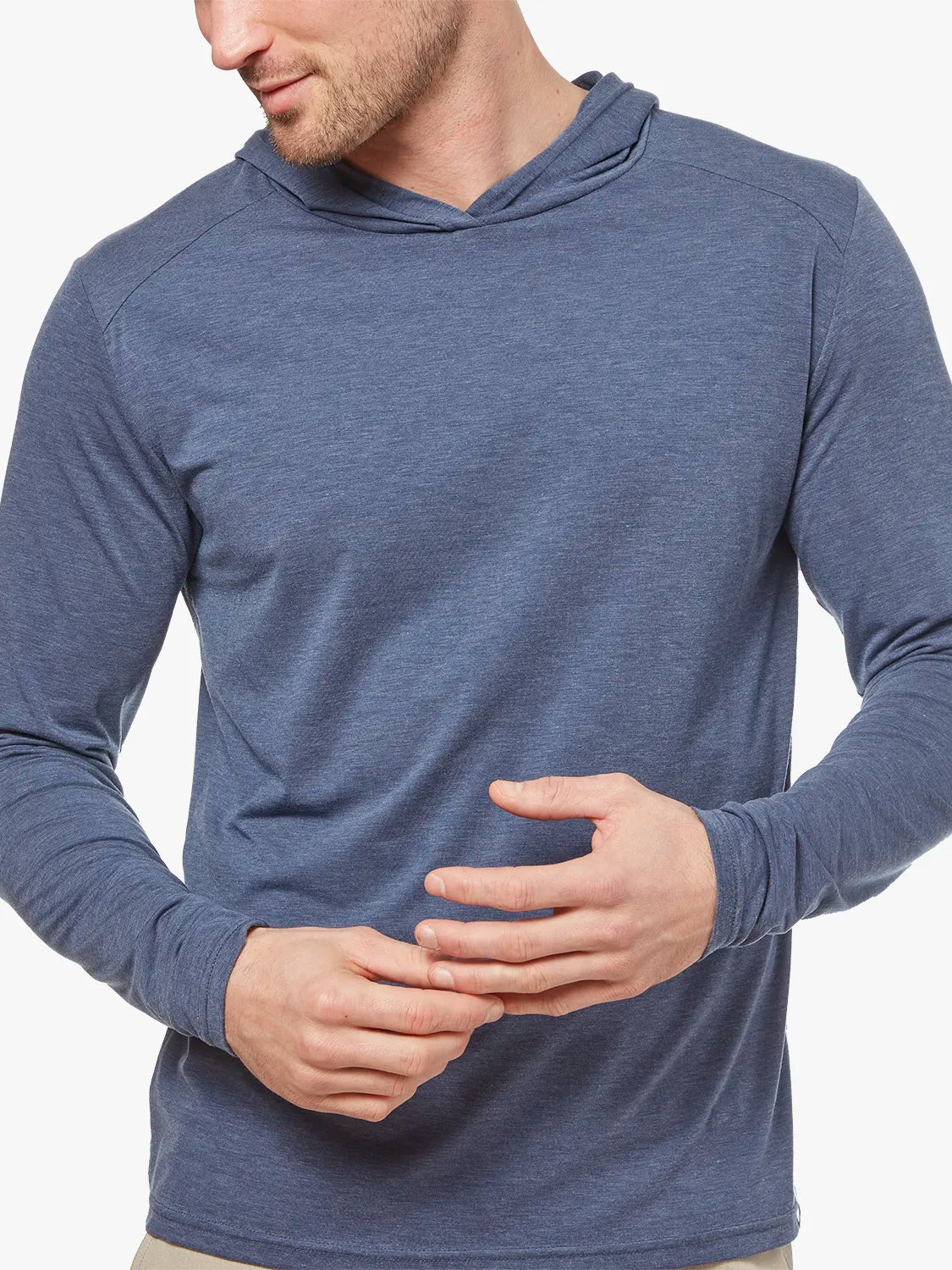 Clouse up of person wearing navy blue seabreeze hoodie on a white background, showing the fabric. 