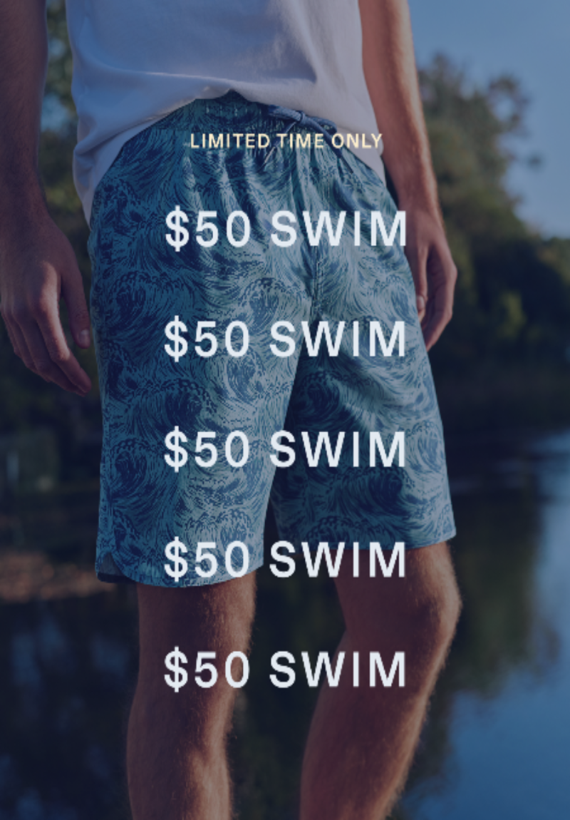 A person outdoors by the water wearing blue patterned swim shorts with large white text reading '$50 SWIM' repeated vertically, plus smaller text at the top reading 'LIMITED TIME ONLY'.