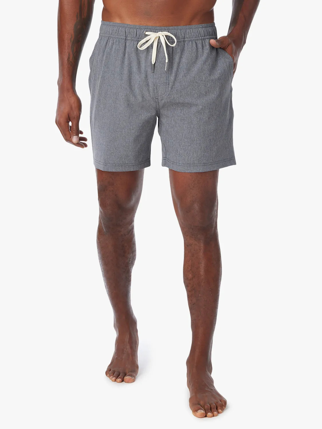 Man wearing a grey one shorts in 6 inch inseam with a drawstring on a white background