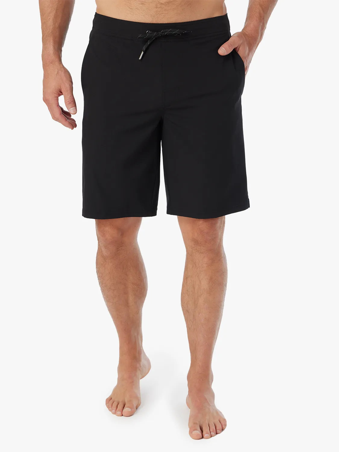 Person wearing pair of black Ozone shorts with drawstring on a white background