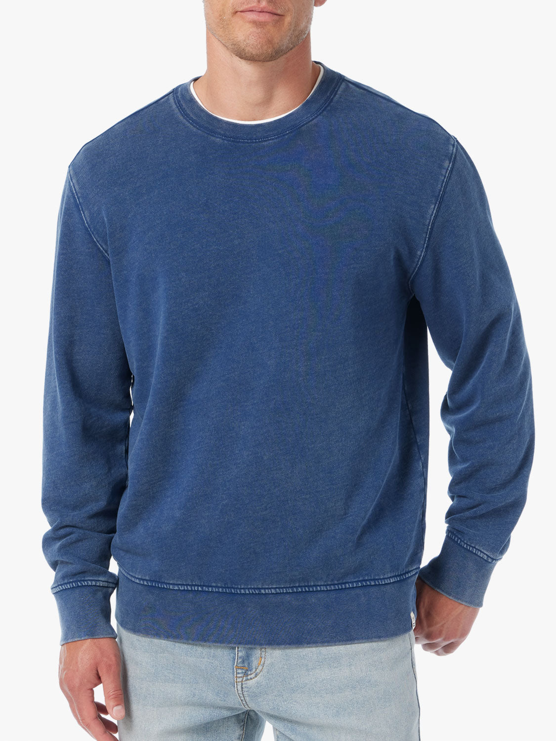 Man wearing navy blue saltaire sweatshirt on a white background